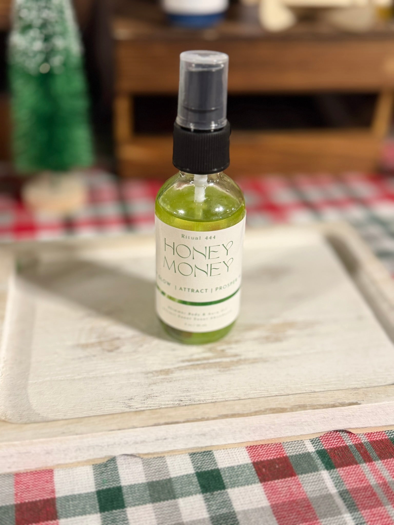 Bottle of Honey Money product on a white wooden plate.